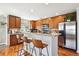 Modern kitchen with stainless steel appliances, a breakfast bar, and ample cabinet space at 9066 Apache Plume Dr # E, Parker, CO 80134