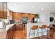 Stylish kitchen featuring stainless steel appliances, a breakfast bar, and hardwood floors at 9066 Apache Plume Dr # E, Parker, CO 80134