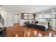 Well-lit living room with hardwood floors, a comfortable couch, and a view into the dining area at 9066 Apache Plume Dr # E, Parker, CO 80134