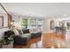 Inviting living room featuring hardwood floors, large windows with bright, natural light and cozy furnishings at 9066 Apache Plume Dr # E, Parker, CO 80134