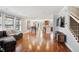 Bright and spacious living room with hardwood floors flowing into the dining and kitchen areas at 9066 Apache Plume Dr # E, Parker, CO 80134