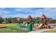 Community playground area featuring slides, benches, and ample green space for recreational activities at 9066 Apache Plume Dr # E, Parker, CO 80134