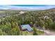 Secluded mountain home surrounded by lush green forest with mountain views in the distance at 11608 Apache Trl, Conifer, CO 80433