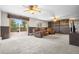 The basement features wood paneling, a view to the exterior, three recliners, and ceiling fans at 11608 Apache Trl, Conifer, CO 80433