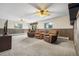 The basement features wood paneling, a view to the exterior, three recliners, and ceiling fans at 11608 Apache Trl, Conifer, CO 80433