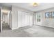 This bedroom features neutral walls, gray carpet, large closet and a door that leads to a small balcony at 11608 Apache Trl, Conifer, CO 80433
