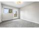 Bright bedroom with neutral walls, carpet and a door leading to a private balcony at 11608 Apache Trl, Conifer, CO 80433