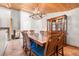View of the dining room featuring a long wood table, wood ceiling, and a beautiful antler chandelier at 11608 Apache Trl, Conifer, CO 80433