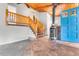 Welcoming entryway featuring a unique wood-burning stove, tiled floor and beautiful staircase at 11608 Apache Trl, Conifer, CO 80433