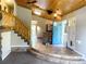 Welcoming entryway with tile flooring, staircase, brick feature and stained-glass doors at 11608 Apache Trl, Conifer, CO 80433
