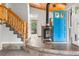 Inviting entryway with a wood-burning stove, stained glass front door, and a staircase with log accents at 11608 Apache Trl, Conifer, CO 80433