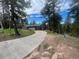 Single-story home features a spacious driveway and a lush green lawn surrounded by trees at 11608 Apache Trl, Conifer, CO 80433