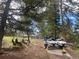 Jet Skis parked on a trailer in a wooded yard, offering convenient access to recreational water activities at 11608 Apache Trl, Conifer, CO 80433