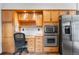 Efficient kitchen with a built-in desk area, stainless steel appliances, and plenty of storage at 11608 Apache Trl, Conifer, CO 80433