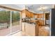 Bright kitchen showcasing granite countertops, a cooktop island, and sliding glass doors to an outdoor deck at 11608 Apache Trl, Conifer, CO 80433