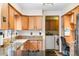 Bright kitchen offering granite counters, cooktop, sink and stainless steel appliances adjacent to laundry room at 11608 Apache Trl, Conifer, CO 80433
