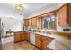 Well-lit kitchen features granite countertops, ample cabinets and a large window offering natural light at 11608 Apache Trl, Conifer, CO 80433