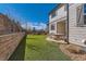 Inviting backyard with stone retaining walls, astroturf, and patio with string lights at 2702 Rising Moon Way, Castle Rock, CO 80109
