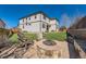 Spacious backyard with a stone fire pit, Adirondack chairs, and lush artificial turf at 2702 Rising Moon Way, Castle Rock, CO 80109