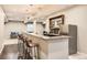 Basement bar area with barstool seating, granite countertops, cabinetry, and a mini refrigerator at 2702 Rising Moon Way, Castle Rock, CO 80109