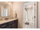 Well-lit bathroom features a granite countertop, updated fixtures, and a door to the shower at 2702 Rising Moon Way, Castle Rock, CO 80109