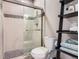 Stylish bathroom features a glass-enclosed shower with decorative tile and a modern toilet at 2702 Rising Moon Way, Castle Rock, CO 80109