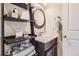 Charming bathroom featuring a vanity with a dark wood cabinet, a white countertop, and a decorative mirror at 2702 Rising Moon Way, Castle Rock, CO 80109