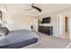 Comfortable bedroom with a dark dresser, carpet and natural lighting from large window at 2702 Rising Moon Way, Castle Rock, CO 80109