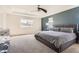 Bright bedroom with a dark accent wall, neutral carpet and comfortable furniture at 2702 Rising Moon Way, Castle Rock, CO 80109