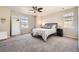 Well-lit bedroom showcases a large window, ceiling fan, and a comfortable bed with stylish decor at 2702 Rising Moon Way, Castle Rock, CO 80109