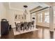 Elegant dining room with modern lighting, stylish décor, and hardwood floors at 2702 Rising Moon Way, Castle Rock, CO 80109