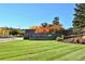 Beautiful entrance to The Meadows neighborhood with manicured lawn and colorful trees in autumn at 2702 Rising Moon Way, Castle Rock, CO 80109