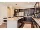 Modern kitchen featuring a spacious island, stainless steel appliances, and dark cabinetry at 2702 Rising Moon Way, Castle Rock, CO 80109