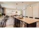 Open kitchen concept with an island and barstool seating, leading to the living area at 2702 Rising Moon Way, Castle Rock, CO 80109