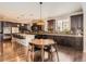 Modern kitchen featuring stainless steel appliances, granite countertops, and dark wood cabinets at 2702 Rising Moon Way, Castle Rock, CO 80109