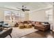 Spacious living room with ample seating, dark hardwood floors and view to the exterior at 2702 Rising Moon Way, Castle Rock, CO 80109