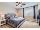 Comfortable main bedroom with a ceiling fan, upholstered headboard, and natural light through the window at 2702 Rising Moon Way, Castle Rock, CO 80109