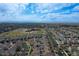 Scenic aerial view of a sprawling residential area with a school and distant mountain range at 5559 Gibraltar St, Denver, CO 80249