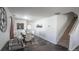 Bright dining room featuring stylish decor, a modern table with white chairs and tile floors at 5559 Gibraltar St, Denver, CO 80249