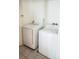 Bright laundry area featuring a white washer and dryer set with tiled floors at 5559 Gibraltar St, Denver, CO 80249