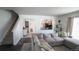 Open living area connecting to the kitchen, complete with a staircase and views of the dining room at 5559 Gibraltar St, Denver, CO 80249