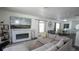 Inviting living room showcases a fireplace and seamlessly connects to a dining area with modern decor at 5559 Gibraltar St, Denver, CO 80249