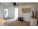 Open loft area with plush carpeting, ceiling fan, and nice natural light at 5559 Gibraltar St, Denver, CO 80249