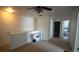 Loft space with a ceiling fan, built in shelving, and access to another room at 5559 Gibraltar St, Denver, CO 80249