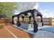 Backyard patio showcasing an outdoor gazebo with comfortable seating and dark-colored curtains at 2359 Dogwood Dr, Erie, CO 80516