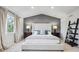 Inviting bedroom featuring soft carpeting, a king bed, and side tables with lamps at 2359 Dogwood Dr, Erie, CO 80516