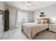 Bright bedroom featuring large window, neutral colored walls, and a wood-frame bed at 2359 Dogwood Dr, Erie, CO 80516