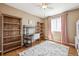 Bedroom featuring hardwood floors, a gray desk, and a natural-toned rug at 2359 Dogwood Dr, Erie, CO 80516