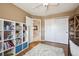 Bedroom features hardwood floors, a white bookshelf, and a white closet door at 2359 Dogwood Dr, Erie, CO 80516