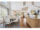 Open-concept dining area features hardwood floors and views of the kitchen and staircase at 2359 Dogwood Dr, Erie, CO 80516